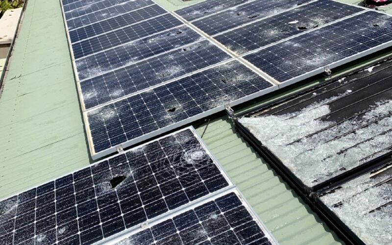 Hail damage to solar modules showing cracked panel surfaces