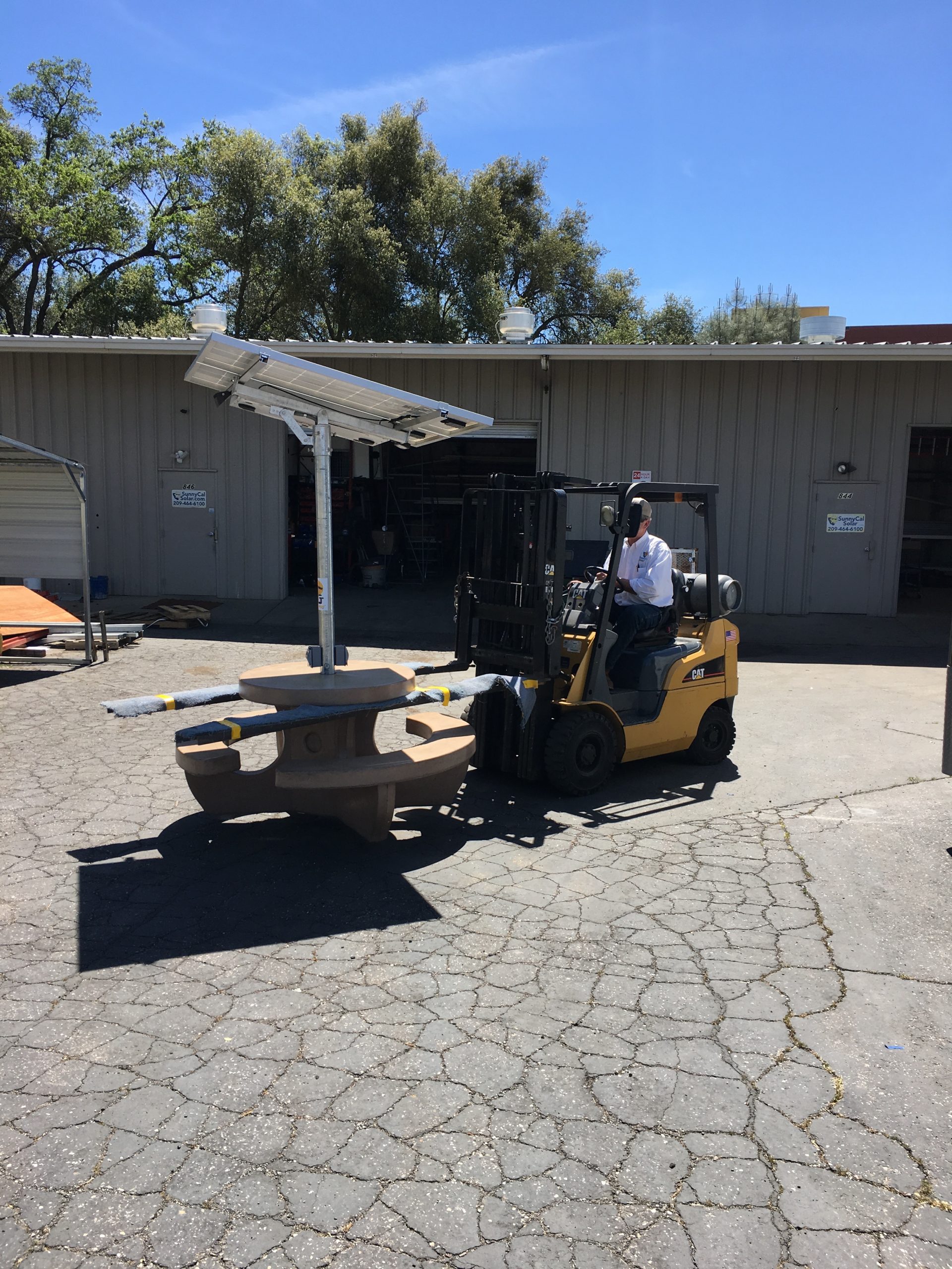 Cafe 1 ShadeCharger solar picnic table prepared for loading and delivery